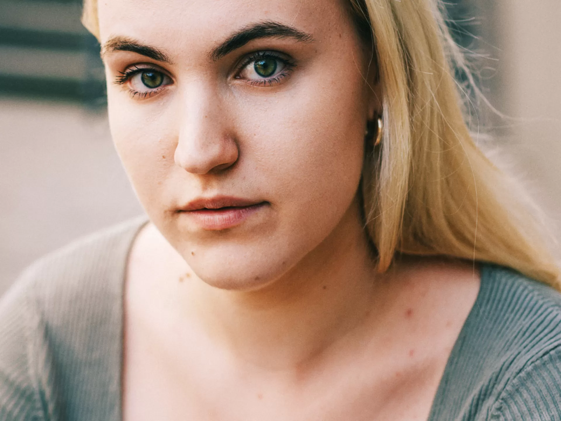 Eine Frau mit blonden Haaren in einer hellgrünen Bluse