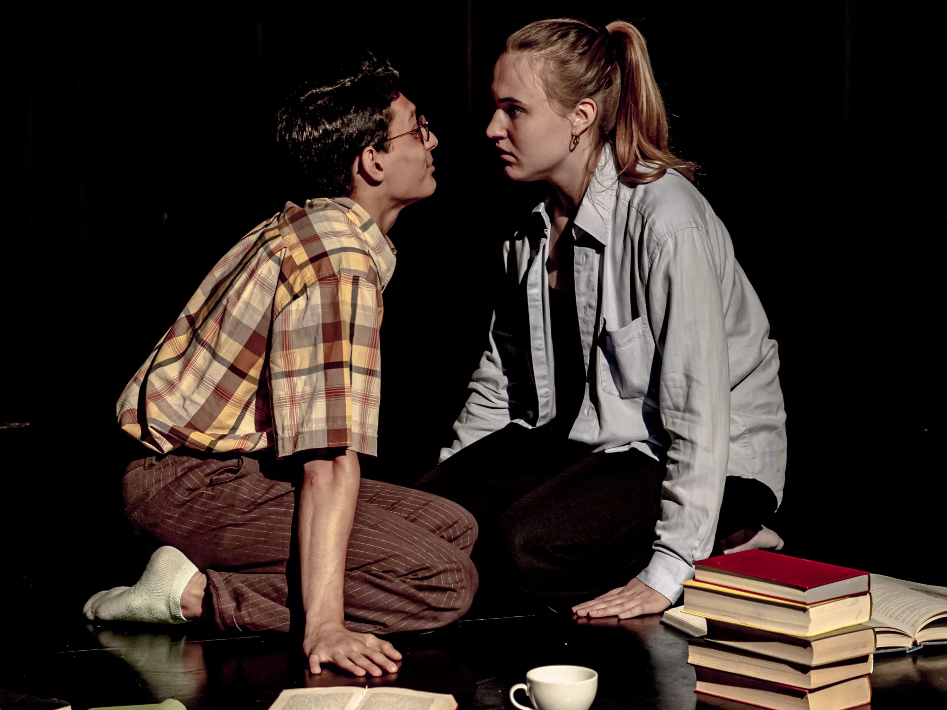 Ein Mädchen und ein Junge sitzen auf dem Boden und schauen sich an