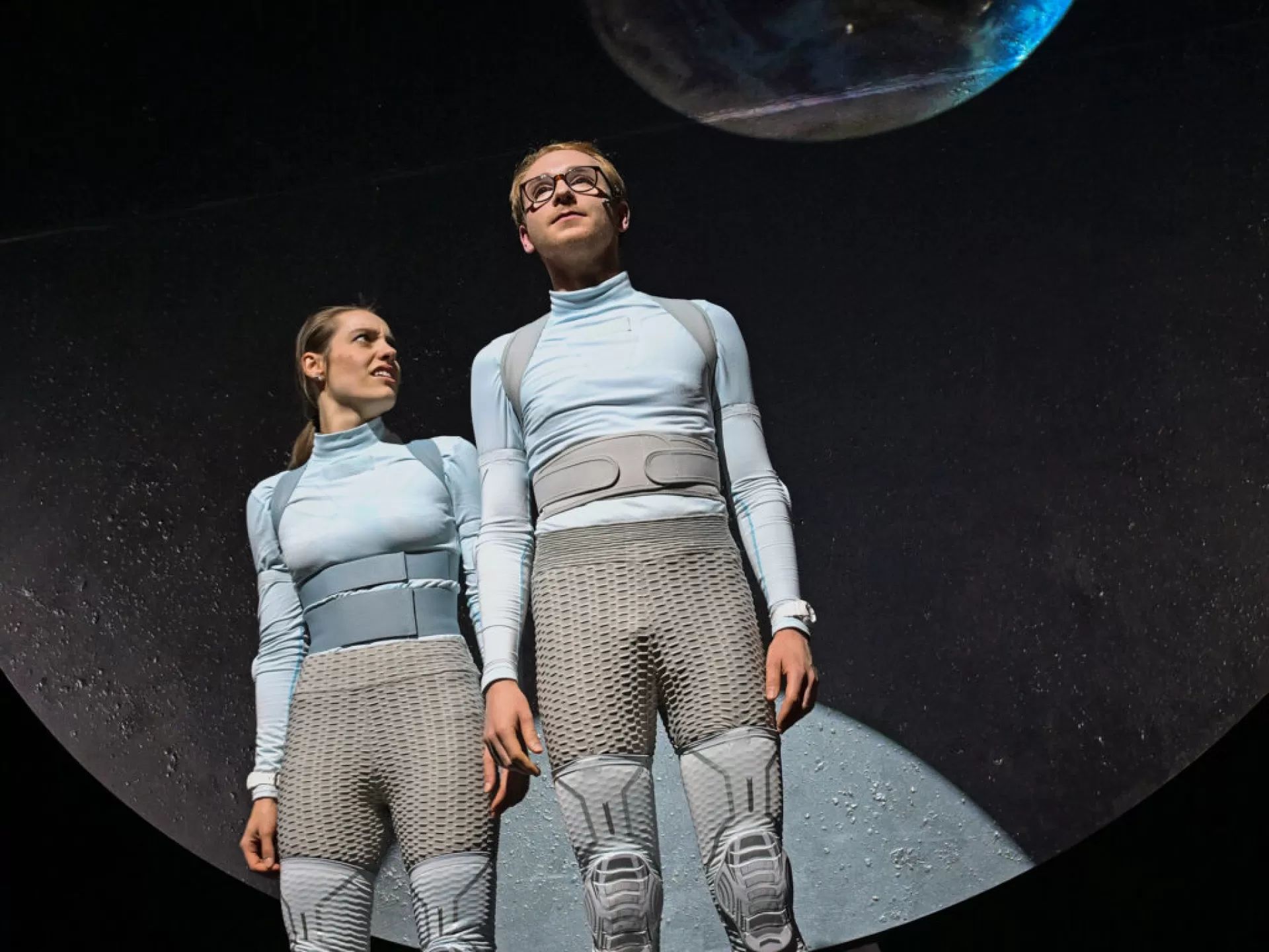 Zwei Personen in Raumfahrtanzügen.