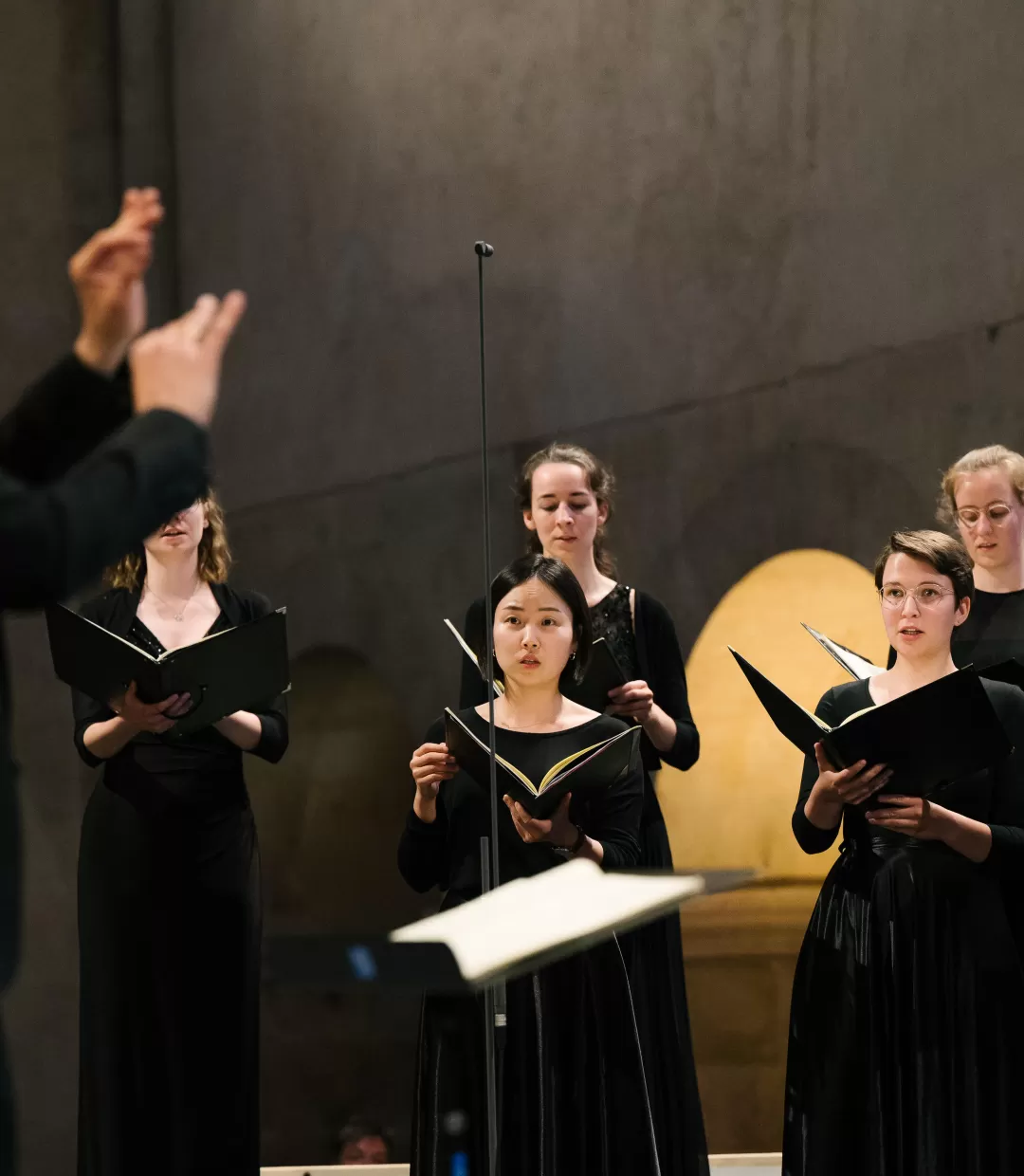Konzert des Kammerchors im Kloster Eberbach. Im Hintergrund Sängerinnen, im Vordergrund (unscharf) Prof. Florian Lohmann.
