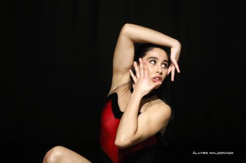 Dancer framing her face with her hands