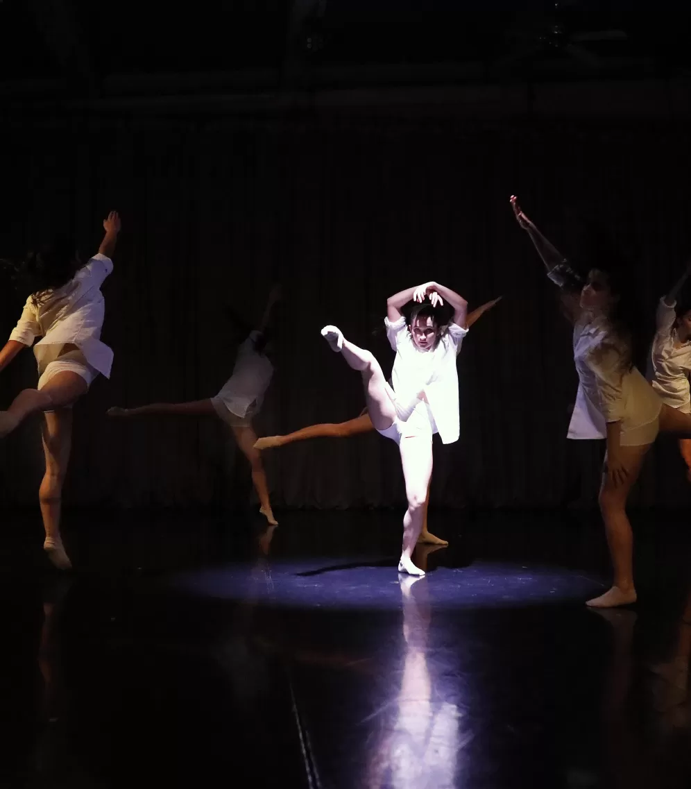 Dancer sorrounded by group of dancers