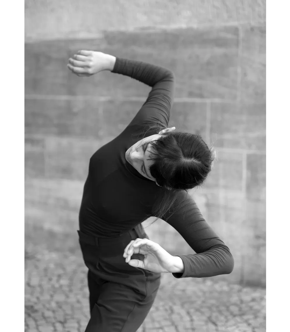 black and white picture of a woman in the street