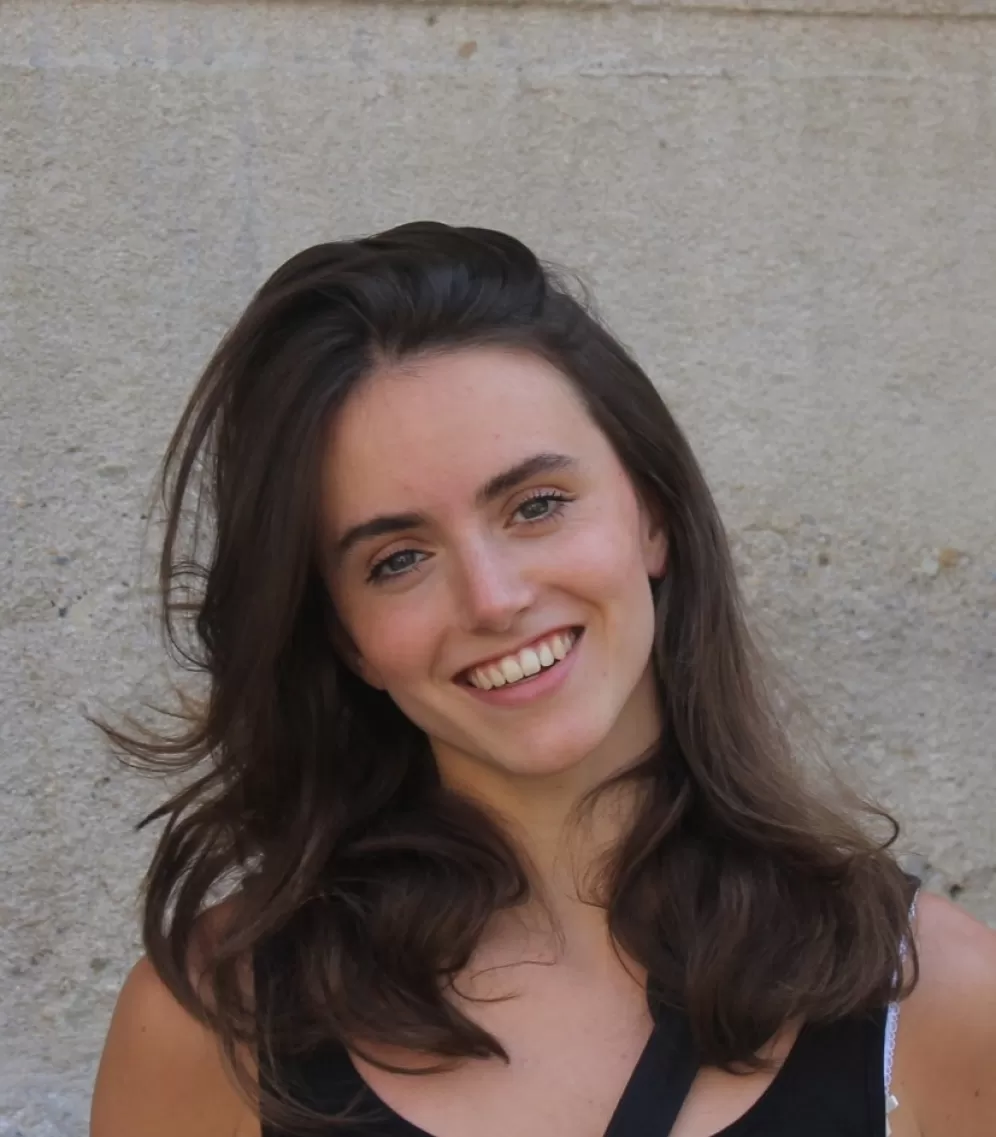 A portrait of a young woman smiling into the camera