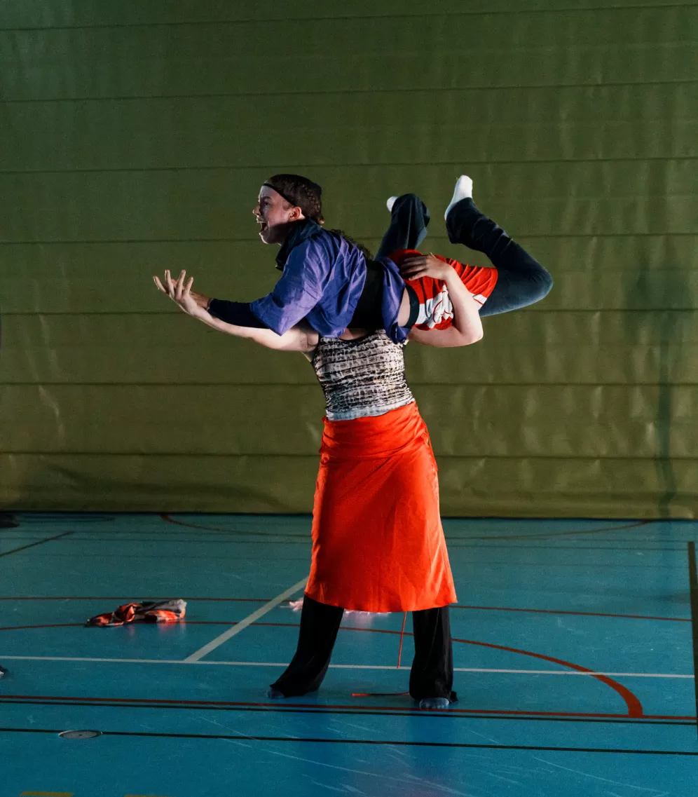 A person holding another with her arms 