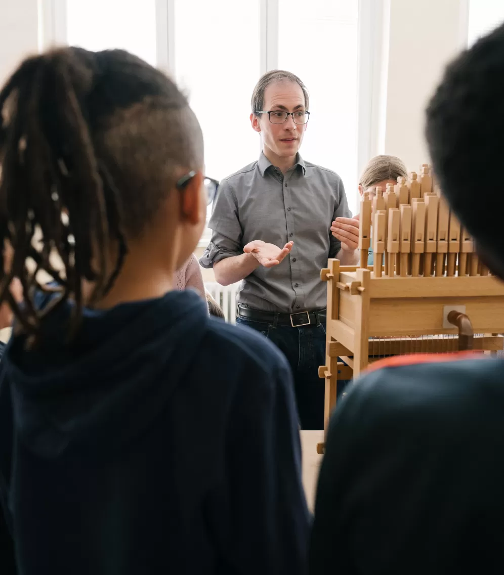 Herr erklärt den Orgelbau beim Musik Monat Mai