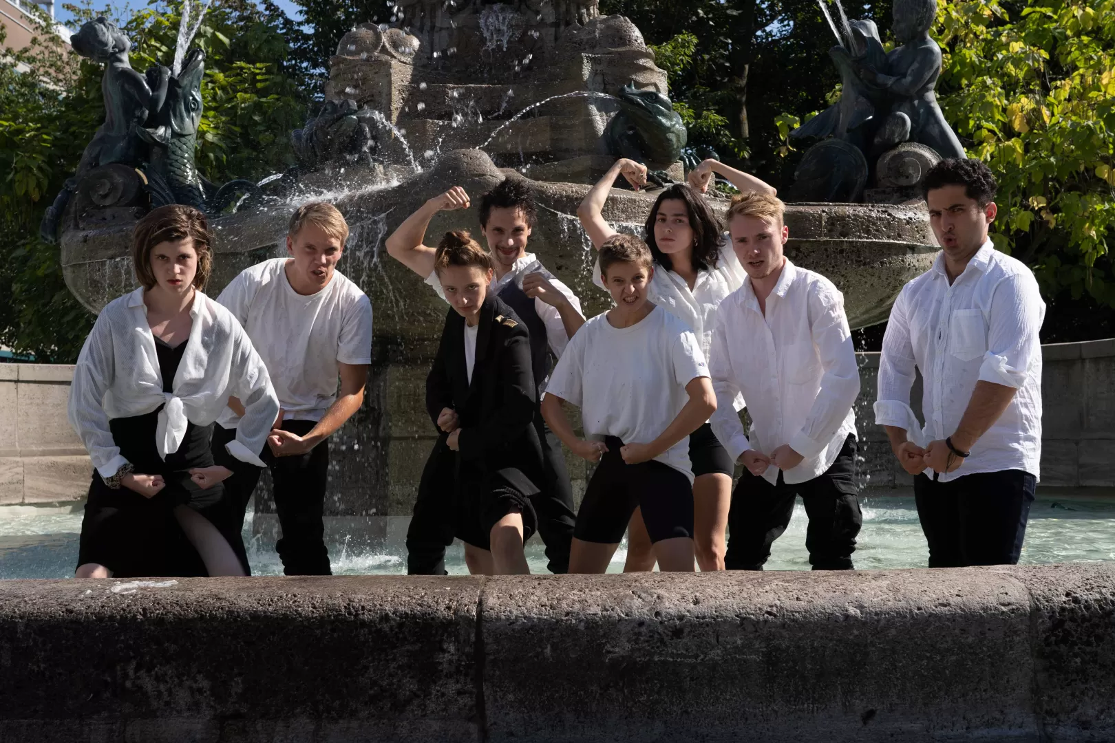 Gruppenfoto im Brunnen, alle machen eine kämpferische Pose.