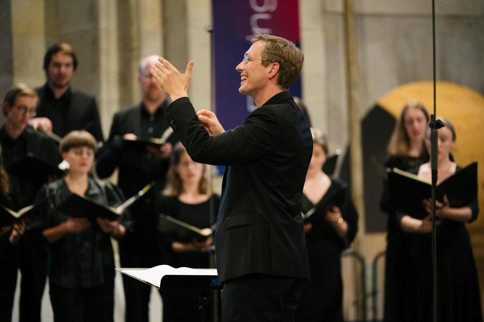 Florian Lohmann dirigiert den Kammerchor während des Konzerts im Kloster Eberbach.