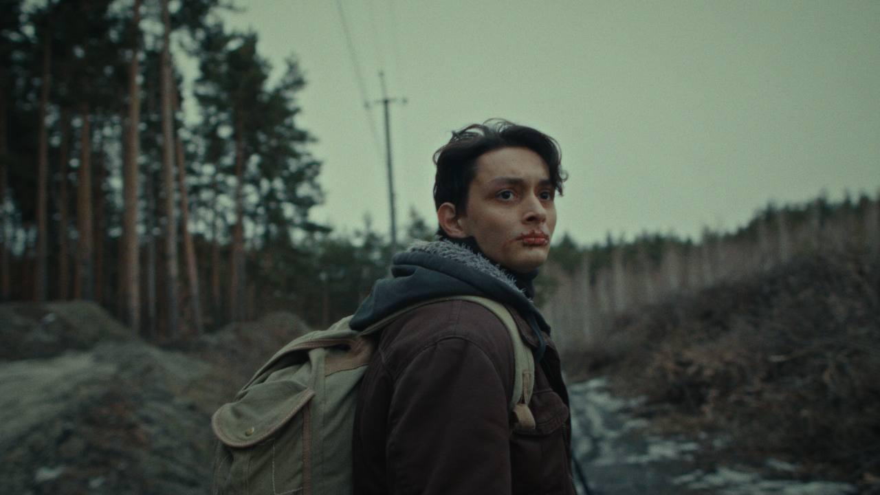 Junger Mann mit Rucksack im Wald.