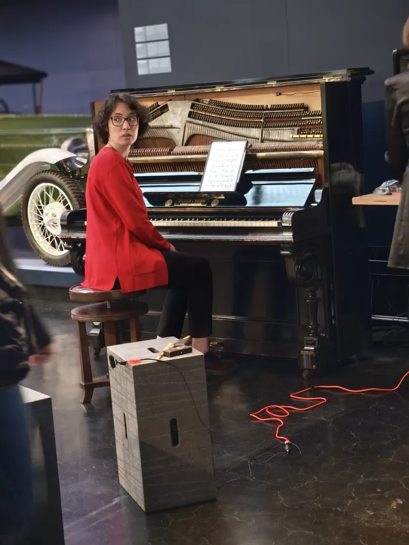 Eine Pianistin sitzt am Klavier schaut nach hinten