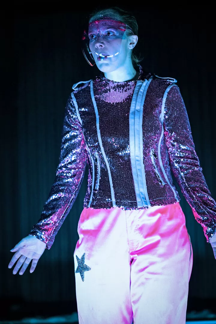 Person in pinkfarbener Kleidung mit pinkem Visier.