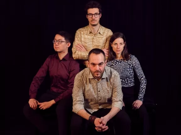 Die vier Musiker*innen des Fabrik Quartets vor einem schwarzen Hintergrund