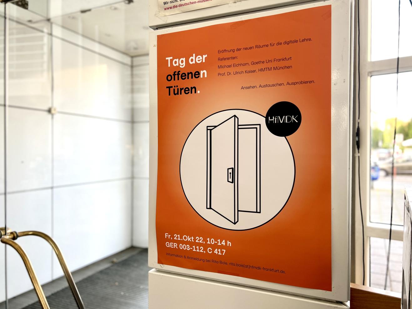 Ein Plakat für den Tag der Digitalen Lehre am 21.10.2022 hängt im Foyer der HfMDK