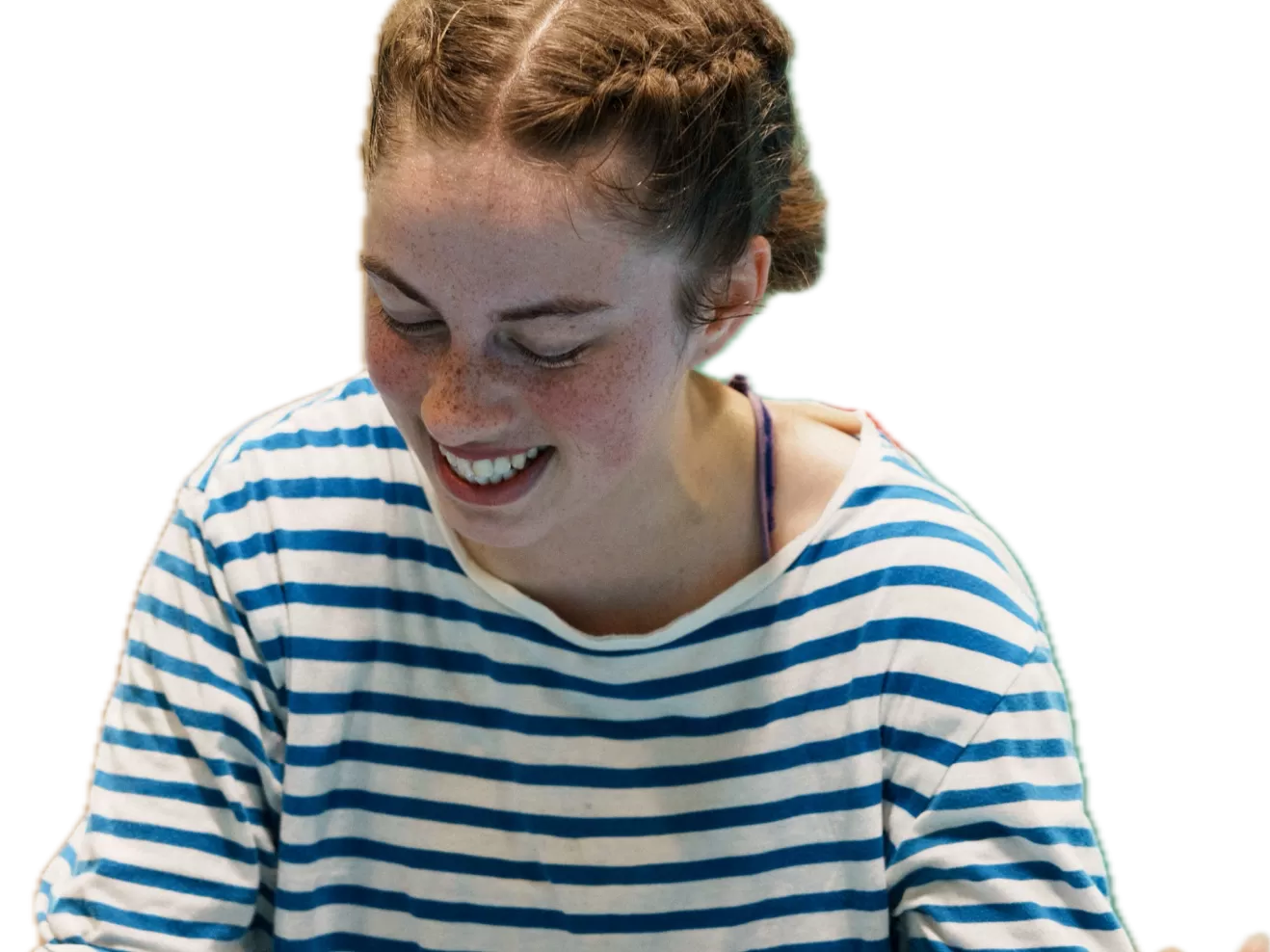 Girl with a striped shirt smiling and looking down